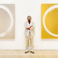 Imperfect circles: Artist Takashi Murakami stands between two works, \"Atlantis\" and \"Shangri-La,\" which are part of his \"Enso\" series. | MARTIN HOLTKAMP