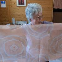 Dyed in the clay: Potter and artist Hiroko Kato holds a piece of finished akatsuchizome, red-clay tie-dye fabric that she created. | STEPHEN MANSFIELD