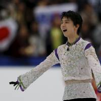 Yuzuru Hanyu reacts after his free skate on Saturday at Nagano\'s Big Hat. Hanyu earned a world-record score of 216.07 points in the free skate a day after shattering his own global mark in the short program. | REUTERS