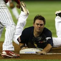 Team USA designated hitter Dan Black slides into third base on Adam Frazier\'s single during the fifth inning on Friday at Tokyo Dome. | AP