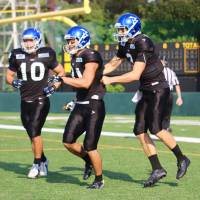 IBM quarterback Kevin Craft (right) celebrates after wide receiver Takashi Kurihara caught a touchdown pass against Asahi Beer in early October in Kawasaki. Craft became the first American to play quarterback in the X League in 2012. KAZ NAGATSUKA | KAZ NAGATSUKA