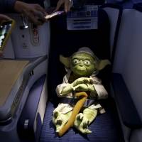 Master Yoda takes a break from fighting the Sith in order to enjoy business class. | REUTERS