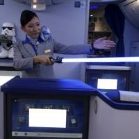 Lightsabers are not only handy for fighting Stormtroopers but also for directing passengers. | REUTERS