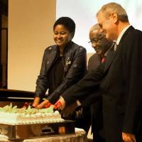 Angola Ambassador Joao Miguel Vahekeni (center) is joined in a cake-cutting ceremony by Namibia Ambassador Sophia Namupa Nangombe (left) and Albert X. Kirchman, president &amp; CEO Head of Daimler Trucks Asia, during a reception to celebrate Angola\'s 40th Anniversary of Independence at the Tokyo Marriott Hotel on Nov. 11. | KAORU KUWABARA