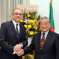 Algerian Ambassador Mohamed El Amine Bencherif (left) welcomes Yoshihiro Shigehisa, chairman emeritus of the JGC group, during a reception to celebrate the country\'s 61st National Day at the Residence of Algeria in Tokyo on Nov. 2. | YOSHIAKI MIURA