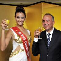 Tunisian Ambassador Kais Darragi (right) poses with Miss Tunisia Wahiba Arres during a reception organized at the ambassador\'s residence on Nov. 6 to celebrate her participation in the Miss International Beauty Pageant 2015. | YOSHIAKI MIURA
