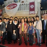 Yoshiomi Tamai (center), founder and president of ASHINAGA (a group that provides educational support for orphaned and bereaved students worldwide), poses with participants and Einosuke Sumitani (right), CEO of the KCJ Group, which operates Kidzania. | YOSHIAKI MIURA