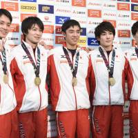 Japan\'s men\'s gymnastics team (above) poses after capturing the gold medal at the world championships in Glasgow, Scotland, in October. | KYODO