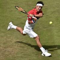Kei Nishikori plays a shot during his match against Dustin Brown at the Gerry Weber Open in Halle, Germany, in June. | AP