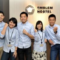 The staff at the Emblem Hostel Nishi-Arai in Tokyo pose for a photo. | YOSHIAKI MIURA