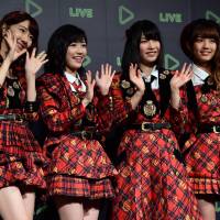 Christmas gift: Japan\'s girl pop group AKB48 members (from left) Yuki Kashiwagi, Mayu Watanabe, Yui Yokoyama and Rena Kato pose for photographs as Japanese social networking service company Line announces the company\'s live streaming service for entertainment, artists\' performances and their daily lives during a press conference in Tokyo on Thursday. | AFP-JIJI