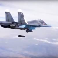 A Russian Su-34 bomber drops bombs on a target on Dec. 9. A new report by a human rights watchdog group accuses Russia of using cluster munitions and unguided bombs on civilian areas in Syria in attacks that it says have killed hundreds of people. The report by Amnesty International released Wednesday says there has been a surge in reports of the use of cluster munitions in the areas being targeted by Russian forces since Moscow formally joined the conflict Sept. 30. | RUSSIAN DEFENSE MINISTRY PRESS SERVICE VIA AP, FILE