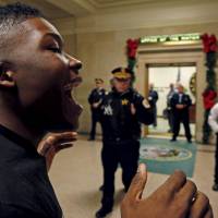 A protester yells during a demonstration outside the office of Chicago Mayor Rahm Emanuel in Chicago on Monday. | REUTERS