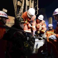 Rescuers try to contact trapped people Monday at a collapsed mine in Pingyi County, east China’s Shandong Province. Chinese state media says rescuers have found eight surviving miners who have been trapped for five days by a collapse at a gypsum mine in eastern China. Eight survivors found five days after Chinese mine collapsed
