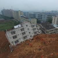 Firefighters search for landslide survivors among debris of destroyed buildings in Shenzhen, Guangdong province, on Monday.  | REUTERS