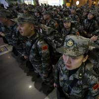 A Chinese medical contingent made up of more than 200 personnel, mostly from a military medical academy and several army hospitals, is seen at an airport in Beijing last November as members prepare to deploy to West Africa to help in the fight against Ebola. | AP