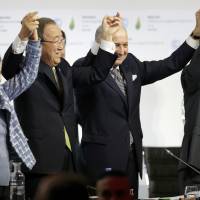 United Nations Framework Convention on Climate Change Executive Secretary Christiana Figueres (left), U.N. Secretary-General Ban Ki-moon (center), French Foreign Minister Laurent Fabius (second from right) and French President Francois Hollande, the COP21 president-designate, raise their arms in triumph during the final plenary session at the World Climate Change Conference 2015 (COP21) at Le Bourget, near Paris, on Saturday. | REUTERS