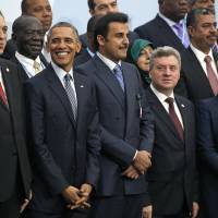 U.S. President Barack Obama (second left) poses with other world leaders for a group photo at the United Nations Climate Change Conference in Le Bourget, outside Paris, on Monday. | AP