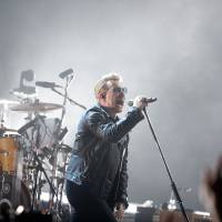 Bono of U2 performs during a concert in Paris Sunday. | AP