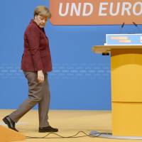 German Chancellor and Christian Democratic Union (CDU) leader Angela Merkel inspects the location for the CDU\'s party congress in Karlsruhe, southwestern Germany, on Sunday. German Chancellor Angela Merkel will seek at her party\'s congress to stamp out dissent in her conservative Christian Democratic Union over a record refugee influx after months of corrosive infighting. | AFP-JIJI