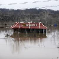 Floodwater from the Bourbeuse River surrounds a McDonald\'s restaurant Tuesday in Union, Missouri. | AP