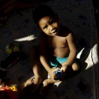 Cuban Jeremy Frometa, 2, sits on a mattress at a shelter in the border between Panama and Costa Rica in Paso Canoas, Panama, Dec. 23. Hundreds of Cubans are stranded on the border between Costa Rica and Panama, after the government of Costa Rica decided not to give them more transit visas, according to local media. | REUTERS