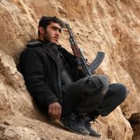 A rebel fighter holds a position near Marj al-Sultan\'s military airport on Thursday, three days after it was recaptured by Syrian troops in the rebel-held Eastern Ghouta region. | AFP-JIJI