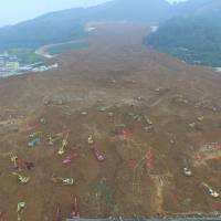 Excavators search for survivors Tuesday at the site of a landslide that hit an industrial park two days earlier in Shenzhen, Guangdong province, China. | REUTERS
