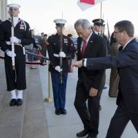 Secretary of Defense Ash Carter welcomes Singapore Minister of Defense Ng Eng Hen to the Pentagon during an honor cordon Monday. | AP