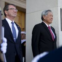 U.S. Secretary of Defense Ash Carter (left) and Singapore Minister of Defense Ng Eng Hen attend a ceremony at the Pentagon on Monday. | AP