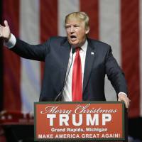 Republican presidential candidate Donald Trump addresses supporters at a Dec. 21 campaign rally in Grand Rapids, Michigan. The former reality television star and tabloid king has relied on free news coverage to power his presidential campaign. And he wants to control that coverage as much as possible. | AP