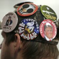 A supporter for Republican presidential candidate Donald Trump listens during a campaign rally Saturday in Davenport, Iowa. | AP