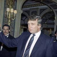 In this 1991 photo, Donald Trump gestures to photographers at a gathering in New York. The same year, Trump, now a Republican presidential candidate, first applied to trademark the name \"Central Park\" to use the words on items including furniture, chandeliers and even key chains. The trademark has been expanded over the years, but records show he first trademarked the name when the city\'s crime rate was near its height and the park had a less-than-glamorous reputation. | AP
