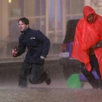 People run as weather sirens sound during a severe storm that passed over downtown Dallas on Saturday. The National Weather Service said the Dallas area was under a tornado warning the same day. Death toll rises to eight in Texas after state is hit by storms that spawned tornadoes