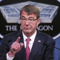 Defense Secretary Ash Carter gestures during a news conference at the Pentagon Thursday to announce that he has ordered the military to open all combat jobs to women, and is giving the armed services until Jan. 1 to submit plans to make the historic change. | AP