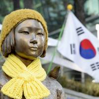 A statue of a girl representing sexual victims of the Japanese military stands in front of the Japanese Embassy in Seoul on Monday. | REUTERS