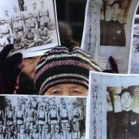 A South Korean whose relatives were victimized in World War II attends a rally in front of the Foreign Ministry in Seoul on Monday demanding full compensation and an apology from the Japanese government.  | AP