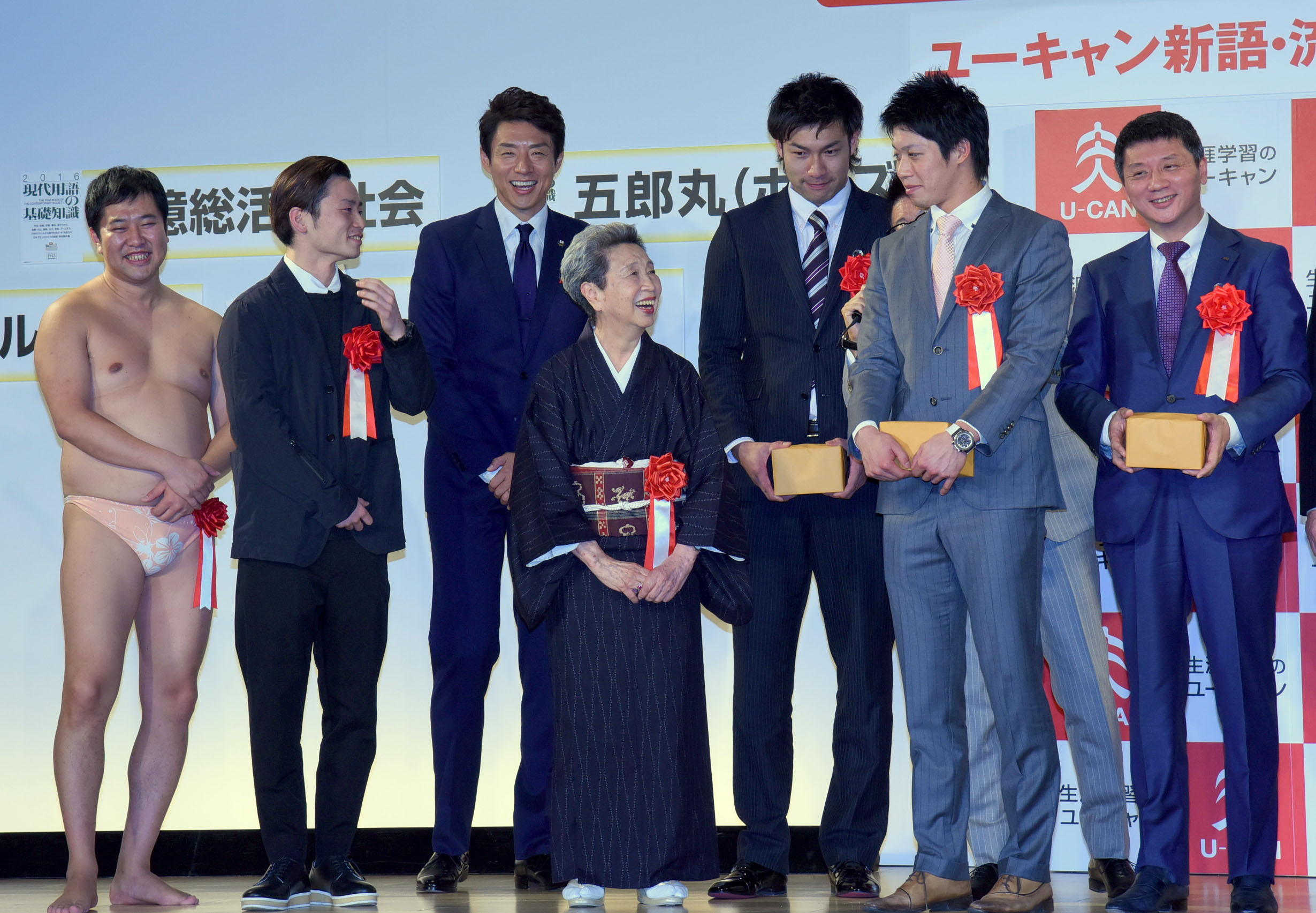 People associated with buzzwords of the year collect their prizes at an awards ceremony in Tokyo on Tuesday. | SATOKO KAWASAKI