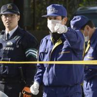 Investigators on Sunday search a residential area around the house where a 17-year-old high school student allegedly killed his grandmother in Kimitsu, Chiba Prefecture. | KYODO