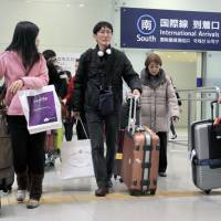 People arrive at Kansai International Airport in Osaka Prefecture last Jan. 4 after spending the New Year\'s holidays overseas. | KYODO