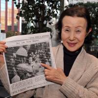 Rumiko Endo holds a copy of the May 13, 1942, edition of The Japan Times. It shows Endo, aged 4 months, and her mother upon their rescue from Dutch internment in the Dutch East Indies by Imperial Japanese troops. Several media outlets reported on their liberation for readers in Japan. | YOSHIAKI MIURA