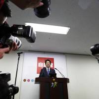Prime Minister Shinzo Abe poses ahead of a news conference following his reappointment as leader of the ruling Liberal Democratic Party in Tokyo on Sept. 23. | BLOOMBERG