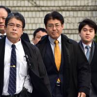 Sankei Shimbun journalist Tatsuya Kato (in yellow tie) arrives for trial at a court in Seoul on Thursday. Sankei journalist Tatsuya Kato acquitted of defaming South Korean leader