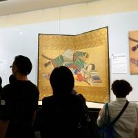 Visitors to a \"shunga\" exhibition look at wood prints and paintings at the Eisei-Bunko Museum in Tokyo on Sept. 18. The exhibition ended Wednesday, drawing more than 200,000 visitors. | KYODO