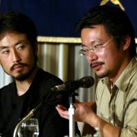 Freelance journalist Jumpei Yasuda (left) and human rights activist Nobutaka Watanabe address the Foreign Correspondents\' Club of Japan in Tokyo in April 2004. | REUTERS