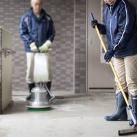 Eiji and Kumiko Ishikawa (not their real names) clean an apartment complex in Tokyo on Dec. 15.  | ROB GILHOOLY