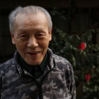 Local resident Isao Miyazaki describes Shiba Daimon in its former years. | KIT NAGAMURA