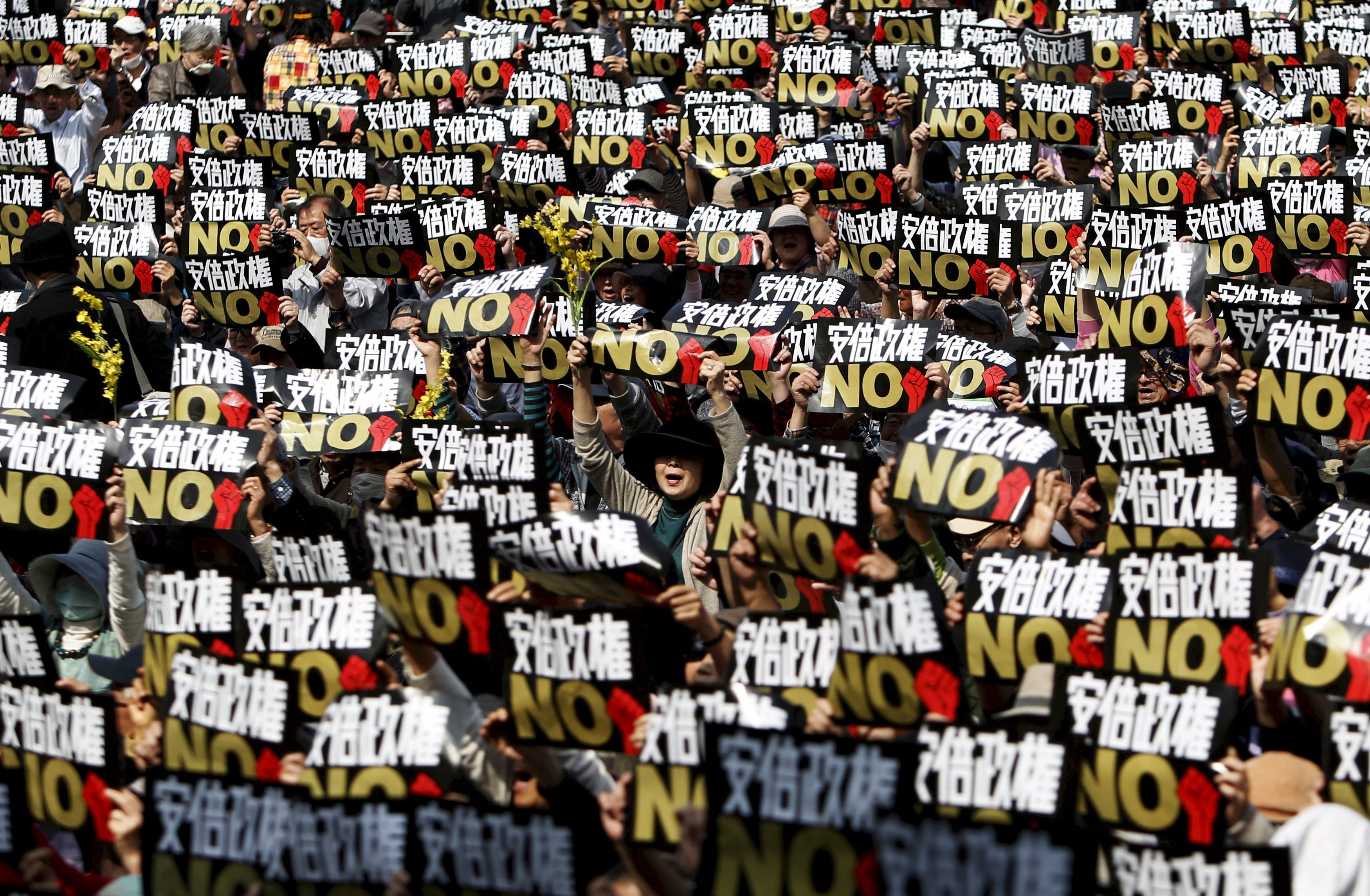 Summer of dissent: Protesters shout slogans at a rally against Prime Minister Shinzo Abe's administration in Tokyo in March. | REUTERS