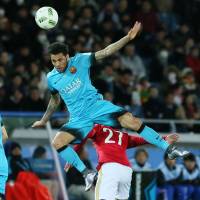 Barcelona\'s Dani Alves leaps over Guangzhou Evergrande\'s Zheng Long to head the ball during Thursday\'s Club World Cup semifinal in Yokohama. | AP
