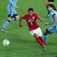 Guangzhou Evergrande\'s Paulinho (left) moves the ball as Barcelona\'s Luis Suarez pursues him on Thursday. AP | AP